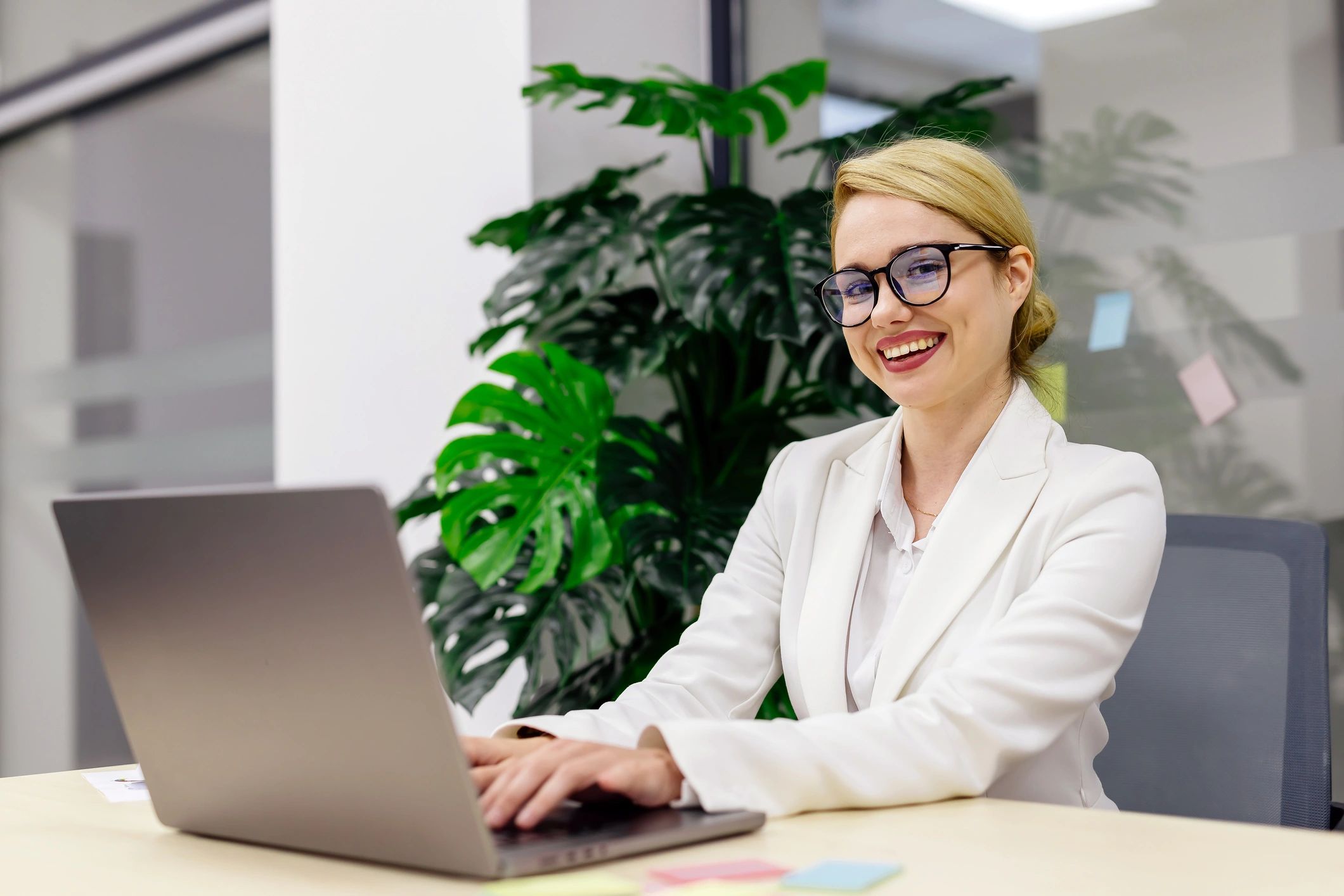 Consultant working confidently on a laptop in a modern office