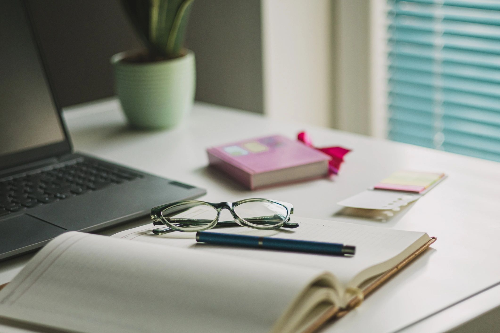 Organized planning desk with laptop, coffee, and office supplies